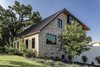 Modern home with Exterior, Metal Roof Material, House Building Type, Wood Siding Material, Brick Siding Material, Metal Siding Material, and Saltbox RoofLine. Bricks from the original bungalow were salvaged and repurposed. Photo 4 of Mullet House