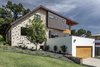 Modern home with Exterior, Wood Siding Material, Metal Siding Material, House Building Type, Stucco Siding Material, Brick Siding Material, Metal Roof Material, and Saltbox RoofLine. The design of the remodel negotiates a 12-foot drop from the front of the lot to the back with a modified roof form that allows for three stories. Photo 5 of Mullet House