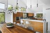 Modern home with Kitchen, Dishwasher, Engineered Quartz Counter, Range, Wall Oven, Cooktops, Microwave, Refrigerator, Stone Slab Backsplashe, Wood Cabinet, Wine Cooler, Ceiling Lighting, Pendant Lighting, Drop In Sink, and Recessed Lighting. Via Media Residence by Matt Fajkus Architecture | Photo by Leonid Furmansky Photo 7 of Via Media Residence