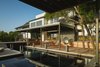 Modern home with Exterior, Wood Siding Material, Stone Siding Material, Stucco Siding Material, Metal Roof Material, and House Building Type. Via Media Residence by Matt Fajkus Architecture | Photo by Leonid Furmansky Photo 3 of Via Media Residence