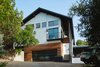 Modern home with Exterior, Stucco Siding Material, Wood Siding Material, House Building Type, and Metal Roof Material. Via Media Residence by Matt Fajkus Architecture | Photo by Leonid Furmansky Photo 5 of Via Media Residence