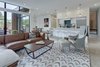 Modern home with Living Room, Light Hardwood Floor, End Tables, Sofa, Chair, Sectional, Coffee Tables, Rug Floor, and Recessed Lighting. Add/Subtract House by Matt Fajkus Architecture | Photo by Charles Davis Smith Photo 4 of Add/Subtract House