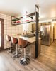 Original kitchen cabinets with new appliances, updates shelf hung from ceiling and full height back splash and original repurposed vertical wood slats Photo 20 of Ron Molen Revival modern home