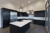 Dark brown cabinets accented with white cabinets Photo 14 of Palisades 14 modern home