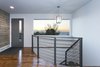 The front entry has a equal blend of oak, cedar and steel railing that creates a great space to soak in the Salt Lake Valley views of the Oquirrh mountain range. Photo 12 of King of the Wasatch modern home