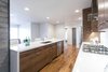 The kitchen island is complete with quiet close hinges and a waterfall counter top. Photo 13 of King of the Wasatch modern home