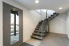 Floating staircase that leads to the walk out daylight basement. Photo 5 of King of the Wasatch modern home