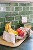 Modern home with Kitchen, Stone Counter, White Cabinet, Medium Hardwood Floor, and Subway Tile Backsplashe. Vintage accessories throughout the home provide a lived in feeling that draws visual interest in all directions. Photo 9 of Going Old School in The Bay Area
