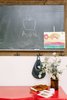 Modern home with Kids Room, Den Room Type, Shelves, Medium Hardwood Floor, Toddler Age, Pre-Teen Age, and Neutral Gender. A chalkboard is the perfect piece to add in a kitchen for jotting down notes, to teaching at home. Photo 4 of Going Old School in The Bay Area