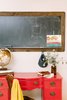 Modern home with Kids Room, Neutral Gender, Medium Hardwood Floor, Toddler Age, Pre-Teen Age, and Den Room Type. A vintage red desk makes for the perfect perch to pay bills or for arts and crafts with the kids. Photo 13 of Going Old School in The Bay Area