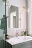 Modern home with Recessed Lighting, Undermount Tub, Ceiling Lighting, Wall Lighting, Drop In Sink, Marble Floor, and Stone Counter. Two sconces featuring LED Edison bulbs add a retro touch and keep the space visually interesting. Photo 10 of Catching Waves In San Francisco