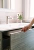Modern home with Drop In Sink, Stone Counter, Undermount Tub, Marble Floor, Enclosed Shower, Ceiling Lighting, Recessed Lighting, Wall Lighting, Marble Wall, and Mosaic Tile Wall. The push front and soft close vanity drawer allows for a clean design with a hardware free design. Photo 7 of Catching Waves In San Francisco