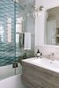 Modern home with Bath Room, Drop In Sink, Undermount Tub, Enclosed Shower, Marble Floor, Engineered Quartz Counter, Ceiling Lighting, Recessed Lighting, Wall Lighting, One Piece Toilet, and Marble Wall. The bathroom received a complete gut and transformed into a custom and calming space for the family to enjoy. Photo of Catching Waves In San Francisco