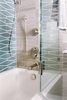 Modern home with Bath Room, Ceiling Lighting, Marble Floor, Undermount Tub, Marble Wall, and Wall Lighting. A custom swing panel glass door provides access to the shower valves without stepping into the shower or damaging the floating vanity which resides next to the tub. Photo 5 of Catching Waves In San Francisco