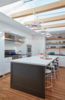 False beams put in place solely to hold those awesome Louis Poulsen lights. Photo 7 of A Danish Inspired Kitchen modern home