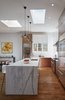 A long counter height island separates guests from kitchen. Photo 5 of A Kitchen for the Boys modern home