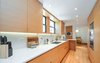 Modern home with Kitchen, Wine Cooler, Dishwasher, Microwave, Cooktops, Wood Cabinet, Quartzite Counter, Wall Oven, Recessed Lighting, Accent Lighting, Refrigerator, Medium Hardwood Floor, Beverage Center, Stone Slab Backsplashe, and Undermount Sink. Kitchen Photo 6 of Town & Country