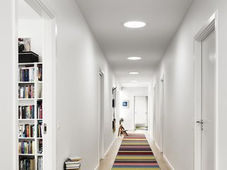 A series of three sun tunnels, or sun pipes, brighten up a windowless corridor.