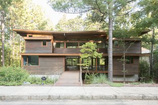 Front yards with older and newer trees create privacy, while granite curbs along the sidewalk indicate the community's attention to quality and detail.