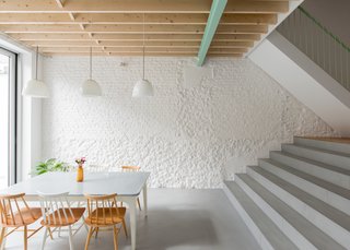 On the ground level, the kitchen is reached by stepping down toward the back of the home, ultimately leading out to a rear yard.

