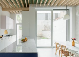Floor-to-ceiling windows allow light to penetrate into the kitchen and the central hallway.