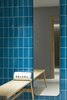 Modern home with Bath Room. The hotel's spa, with walls tiled in a calming blue tone, uses products from a local company. Photo 13 of PURO Kraków Kazimierz