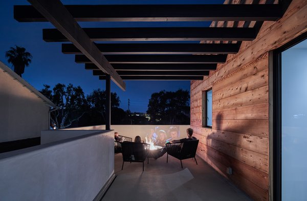 The family often spends evenings in front of the fire pit on the outdoor patio on the second floor.