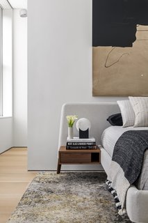 A headboard has integrated wood bedside tables.