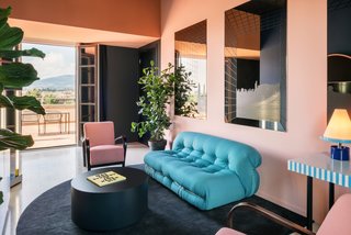 Some rooms feature a warm, pastel color palette with Memphis-inspired pieces.