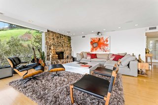 The warm, textured stone of the original fireplace warms up the living area both physically and visually.