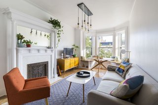 First-time homeowners often call on Sweeten to renovate their new place—in this case, sustainability, maximum storage, and modern lines combine to transform an outdated space into a "happy living room."