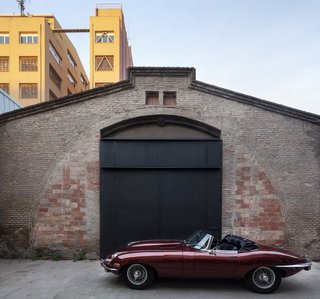 The front door doubles as a garage door for the vintage car, which parks in the front entry at night.