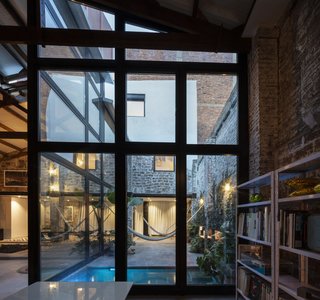 An outdoor patio was created simply by removing a portion of the roof of the building. It acts more as an extension of the interior than as a back or side yard.