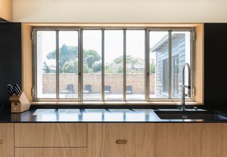 The wide windows in the kitchen allow for views while the residents are in front of the sink or cooking at the long countertop.