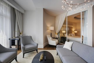 Sleek sliding glass doors divide bedrooms from living spaces in some of the larger suites, allowing light to enter the space while still allowing for physical and acoustic separation if required.