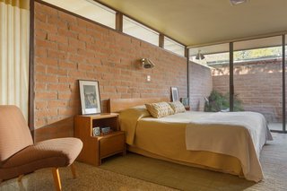 A vintage article in Good Housekeeping magazine illuminated the 1953 Benit House in Houston. When Steve Curry, principal at Curry Boudreaux Architects, and his wife Martha bought it they spent 11 years painstakingly renovating it to resemble its original form in the article, including a red front door, matching planter boxes divided by a glass wall, and sliding doors separating the dining room from the walled garden. But after Hurricane Harvey struck in 2017, the couple were forced to restore it yet again, replacing flooring, woodwork, and rusted metal to bring it back to its midcentury pink brick and terrazzo glory.