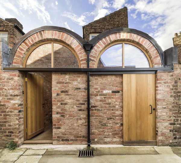 Studio Ben Allen was inspired by the textured brick "landscape" of the neighborhood. The same type of local, handmade brick from the existing home was used for the extension, creating an almost seamless transition between the two.