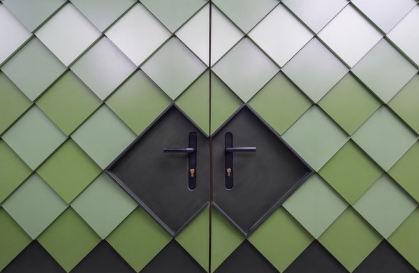 The gradient of dark to light green mimics the tones of the greenery around the pavilion.