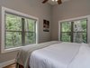 Modern home with Bedroom, Bed, Medium Hardwood Floor, and Ceiling Lighting. Typical king bedroom. Bedding is consistent with a luxury hotel room, featuring perfect sleeper mattresses and microfiber linens. Guests enjoy a strong connection to the surrounding forest throughout the interior spaces, particularly in the bedrooms. Photo 8 of Pilot Cove : Forest Lodging