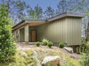 Modern home with Exterior, House Building Type, Metal Roof Material, Wood Siding Material, and Concrete Siding Material. Exterior of one bedroom cabin. Efficiency, one bedroom, and two bedroom units are available for rent. Efficiency cabins are best suited for single occupancy or a couple, one bedroom cabins can sleep up to 4, and two bedroom cabins can sleep up to 6. Photo 3 of Pilot Cove : Forest Lodging