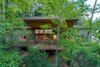 Modern home with Outdoor. Each cabin at Pilot Cove is designed to integrate with the surrounding forest landscape, giving the experience of a treehouse. The shed roof design and ample rear windows allow for light-filled interior spaces while also preserving guest privacy. Photo 4 of Pilot Cove : Forest Lodging