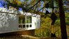 Cantilevered upper level appears to almost float above the stone. Photo 6 of Phelps Residence modern home
