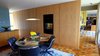 Dining Room with Platner table and Pollack chairs. Computer and television screen controlled by wifi is invisible when off. Master Bedroom is beyond on right. Photo 12 of Phelps Residence modern home