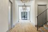 Large entry way hall with gorgeous iron front doors. Photo 2 of Braes Heights Home- Merrick modern home