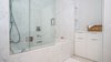 Custom Designed (by Boudreaux Design Studio) Master Bath with integrated towel tower and cabinet featuring pull out hamper. Photo 6 of Roney Palace Modern Remodel modern home