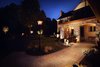 We installed a wider paver walkway, added a Bevelo handcrafted antiqued gas lantern, numerous LED lights that splashed against the stone and stucco to create an inviting side entry. Photo of The Kalimtzis Residence modern home