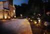 The macadam driveway was unattractive. Decorative pavers were added to the center of the driveway to break up the macadam and expand the now welcoming front walkway and entrance. Photo 2 of The Kalimtzis Residence modern home