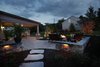 We continued the patio beyond the roofline for a more open feel and added a natural gas fire pit and seating walls as an entertainment focal point. Photo 3 of The Stitt Residence modern home