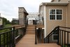 This switch-back staircase connects the downstairs patio level to the upstairs outdoor kitchen and dining area. Photo 3 of The Nowak Residence modern home