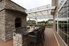 This client loves to cook, so an outdoor kitchen and dining area was essential. The grilling area uses the same chase as the lower level fireplace, which adds innovation as well as functionality. Photo 4 of The Nowak Residence modern home